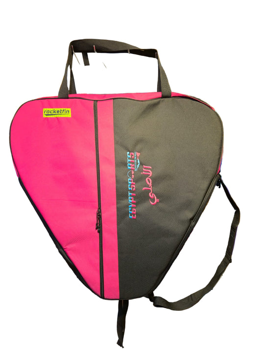 Pink and black racket bag with visible branding in a store setting